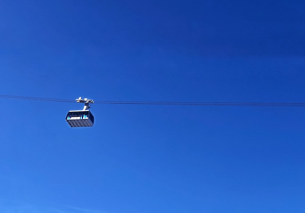 black cable car under blue sky during daytime