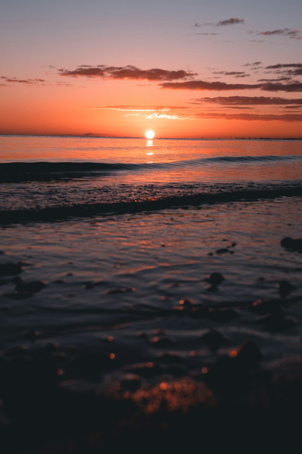 body of water during sunset