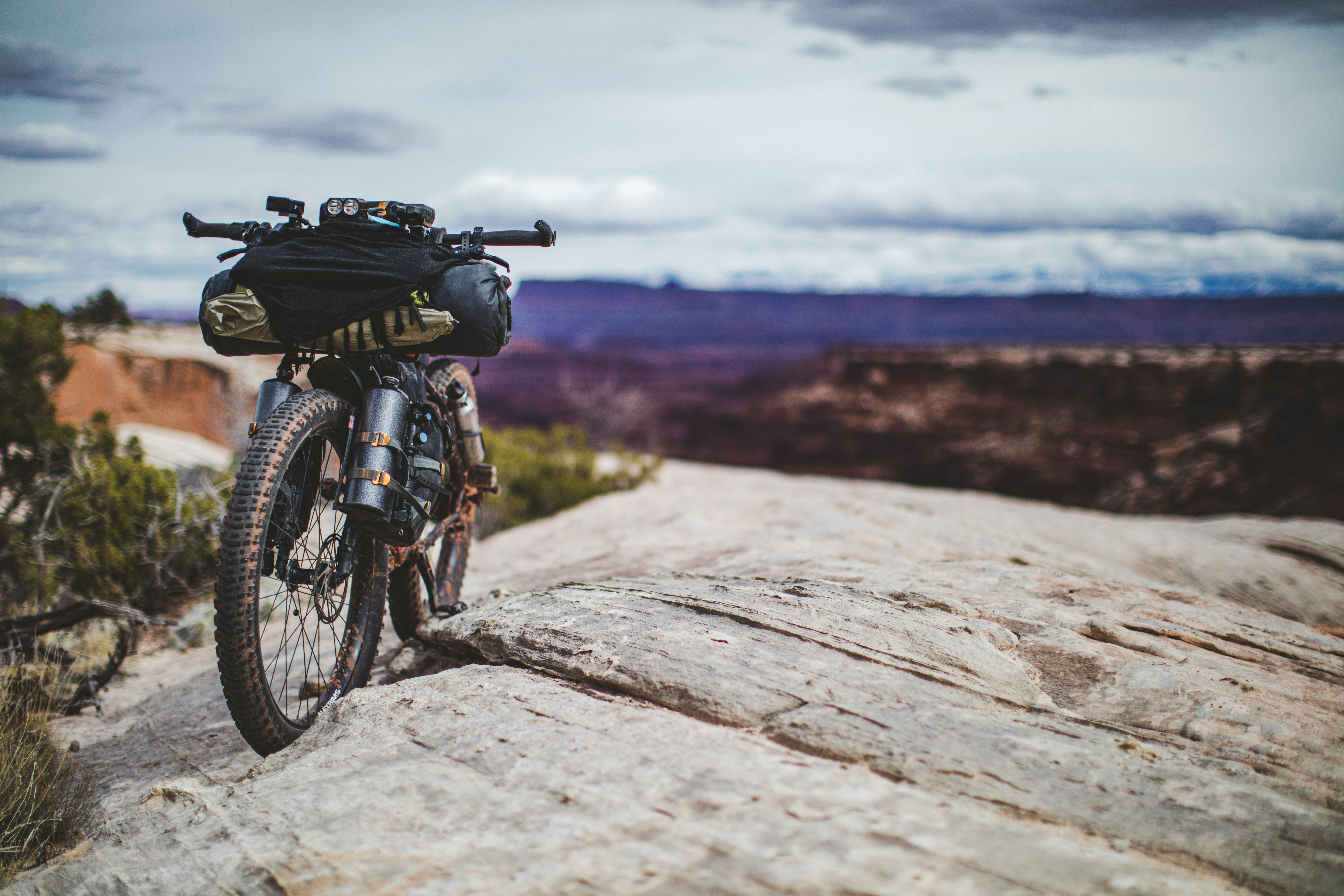 black motorcycle parked on brown rock during daytime