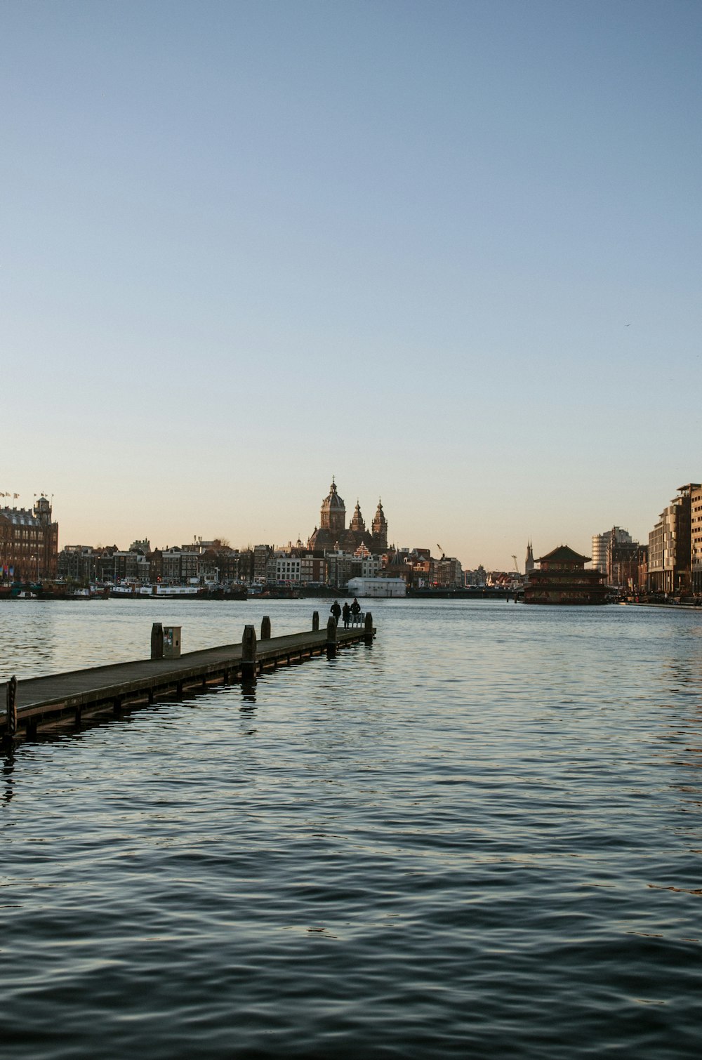 body of water near city buildings during daytime