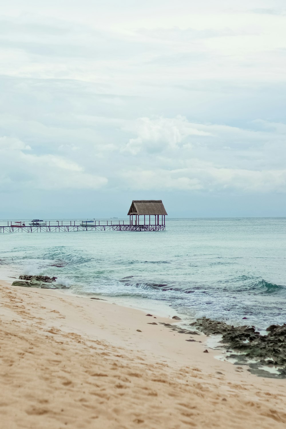 brown wooden beach house on beach during daytime