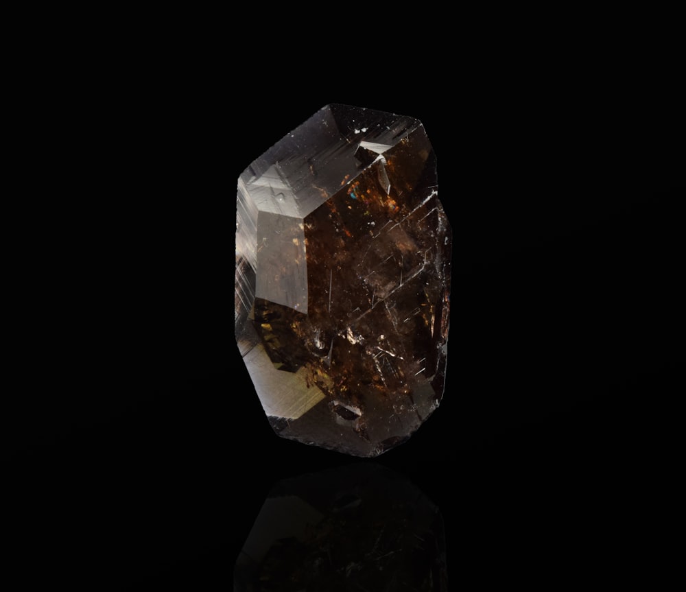 clear crystal stone on black surface