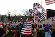 people holding us a flag during daytime