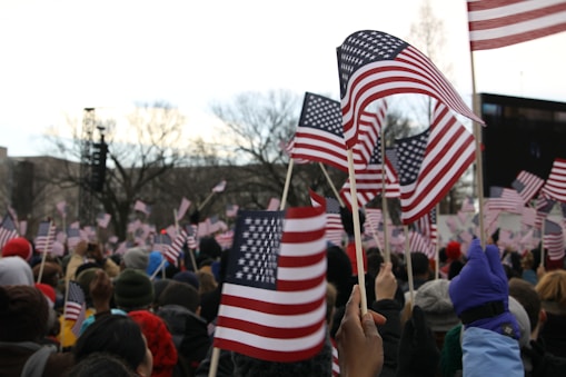 people holding us a flag during daytime