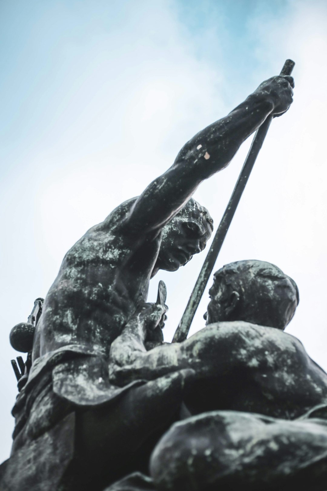 man holding a rope statue