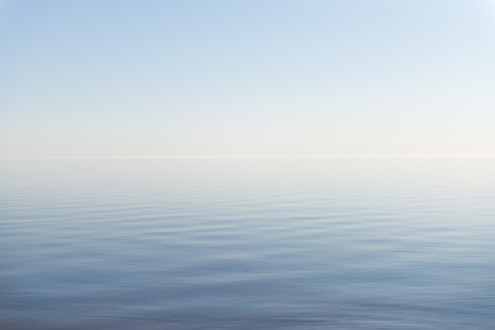 blue body of water under blue sky during daytime