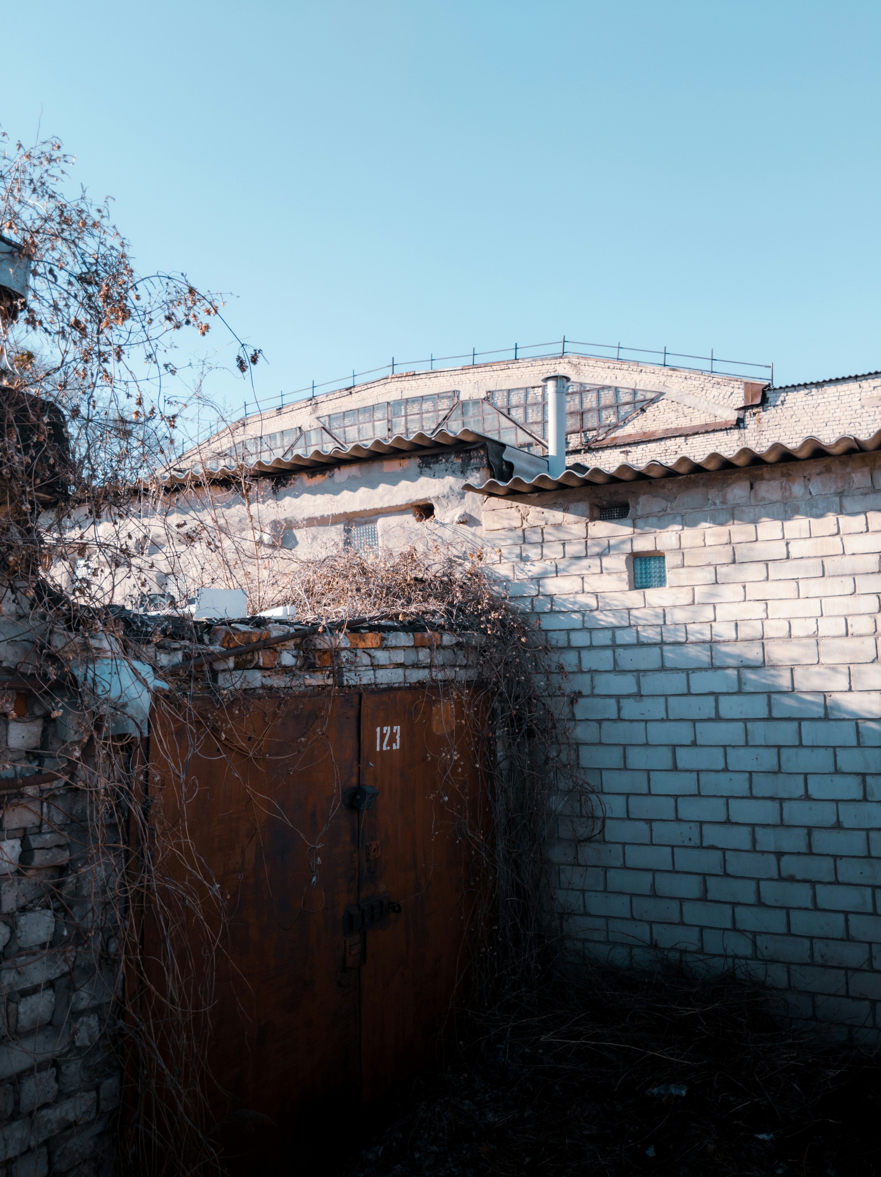 brown wooden door on brown brick wall