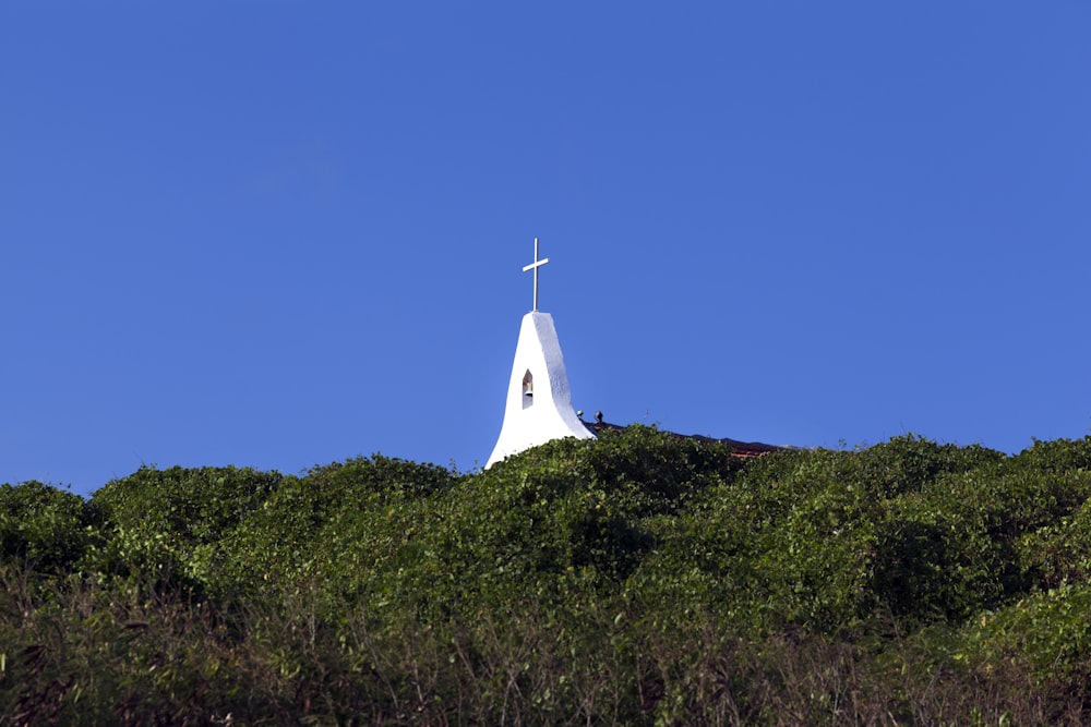 white church on green grass field under blue sky during daytime