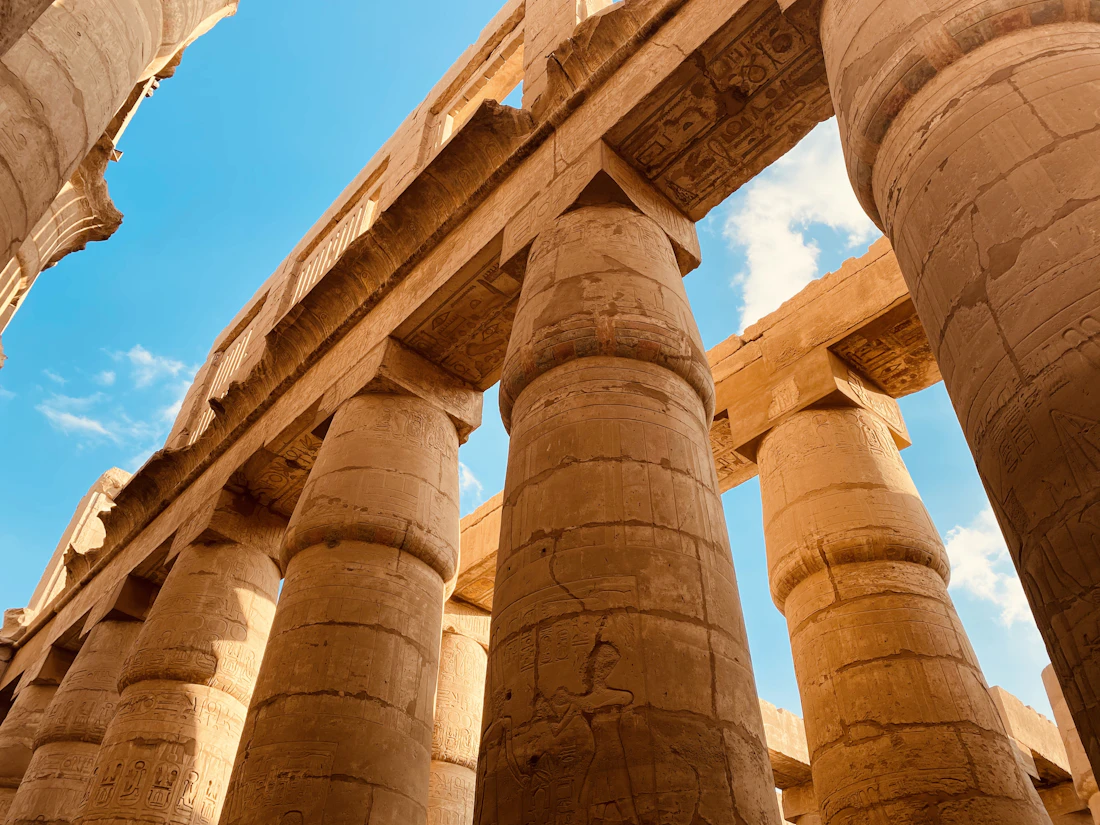 The towering sandstone columns of the Great Hypostyle Hall at Karnak Temple in Luxor, Egypt