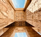 low angle photography of brown concrete building under blue sky during daytime