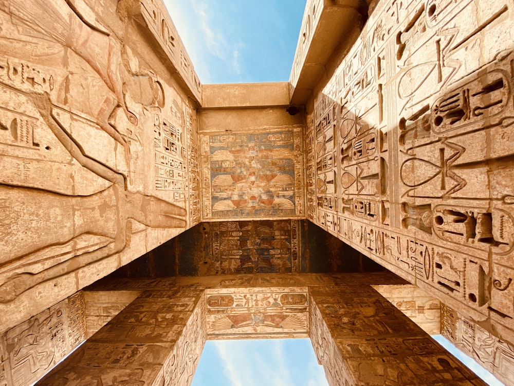 low angle photography of brown concrete building under blue sky during daytime