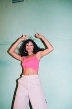 woman in pink tank top and white shorts