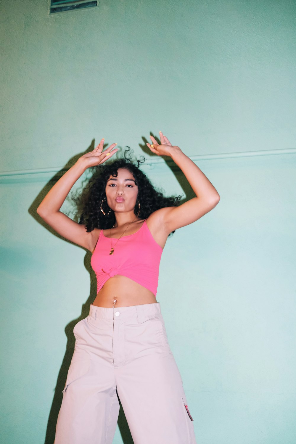 woman in pink tank top and white shorts