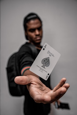 man holding ace of spade card