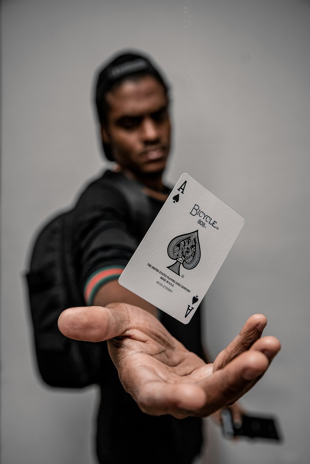 man holding ace of spade card
