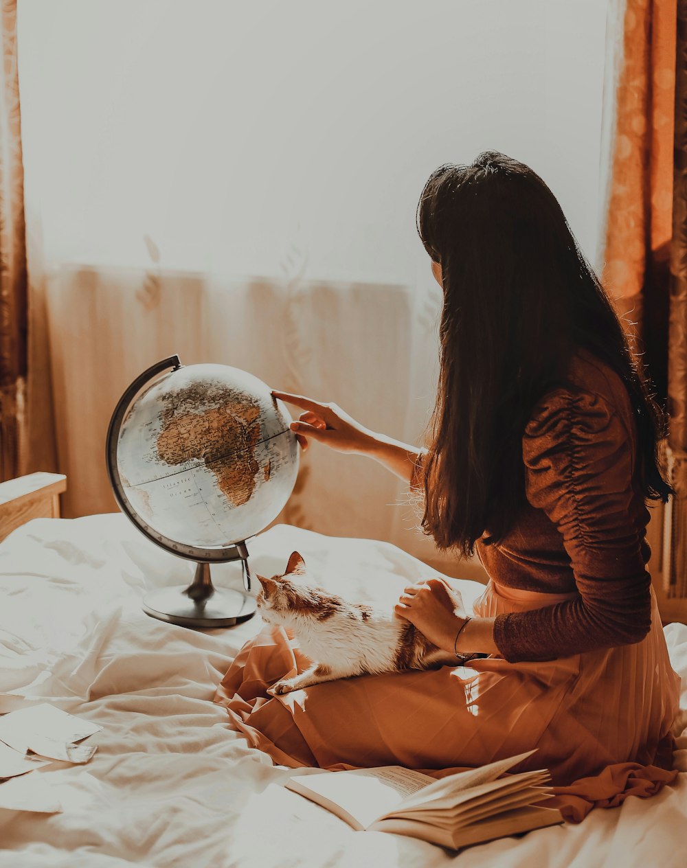 woman in brown long sleeve shirt sitting on bed