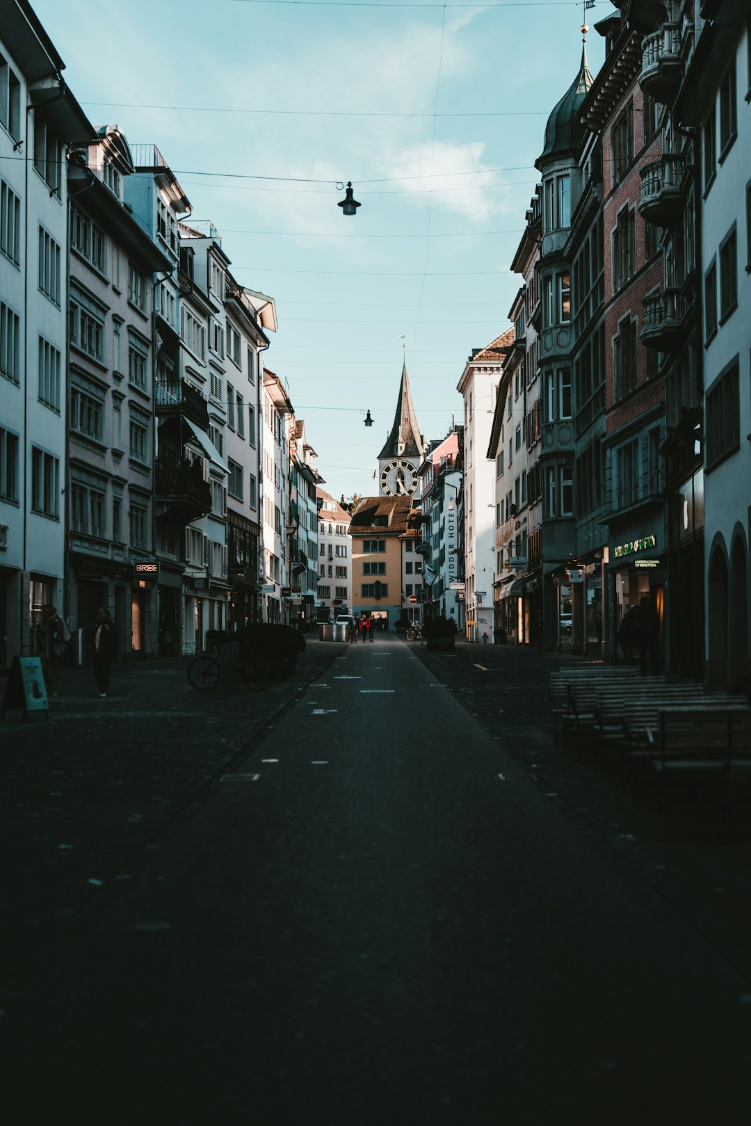 black car on road between buildings during daytime