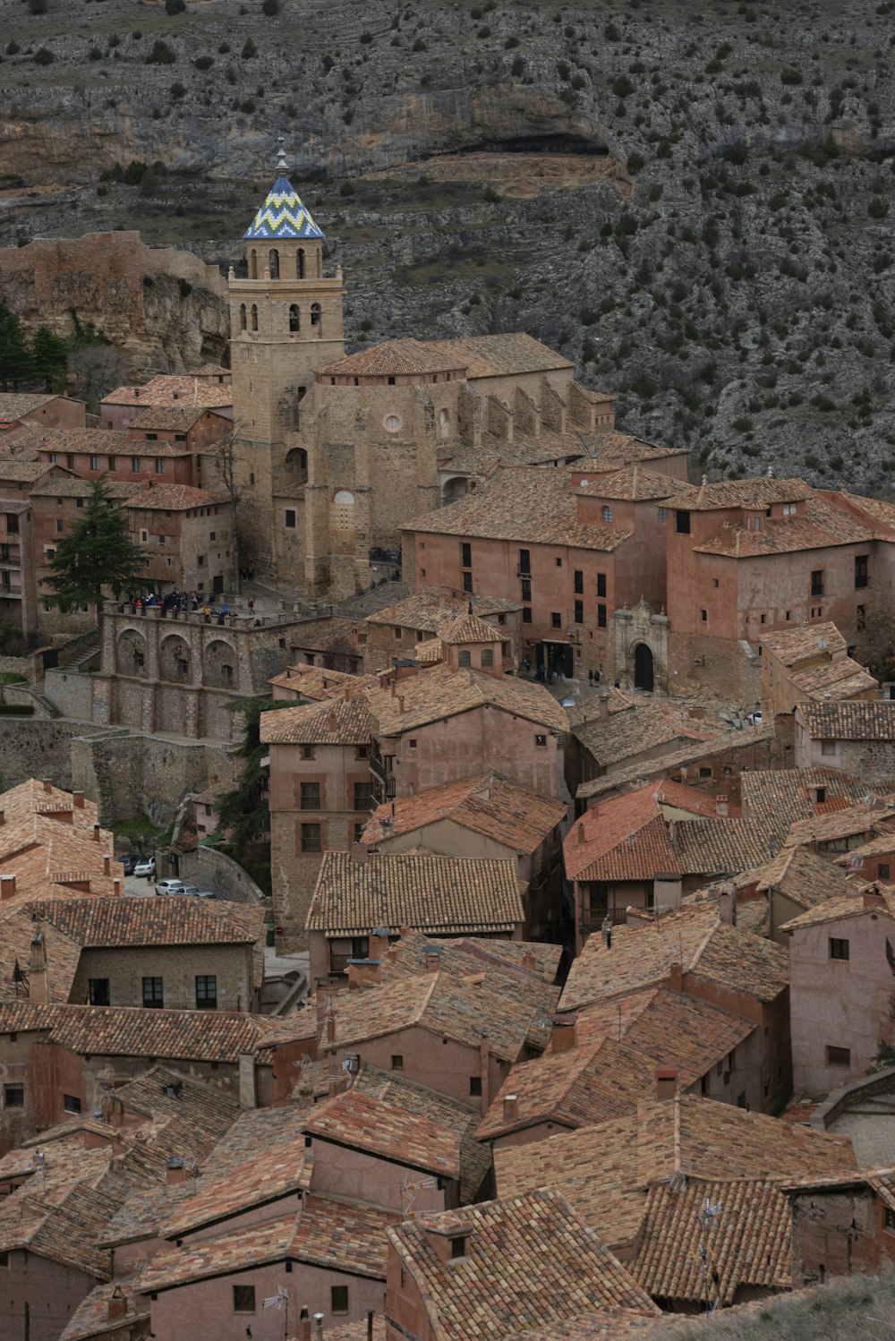 brown concrete houses near mountain during daytime