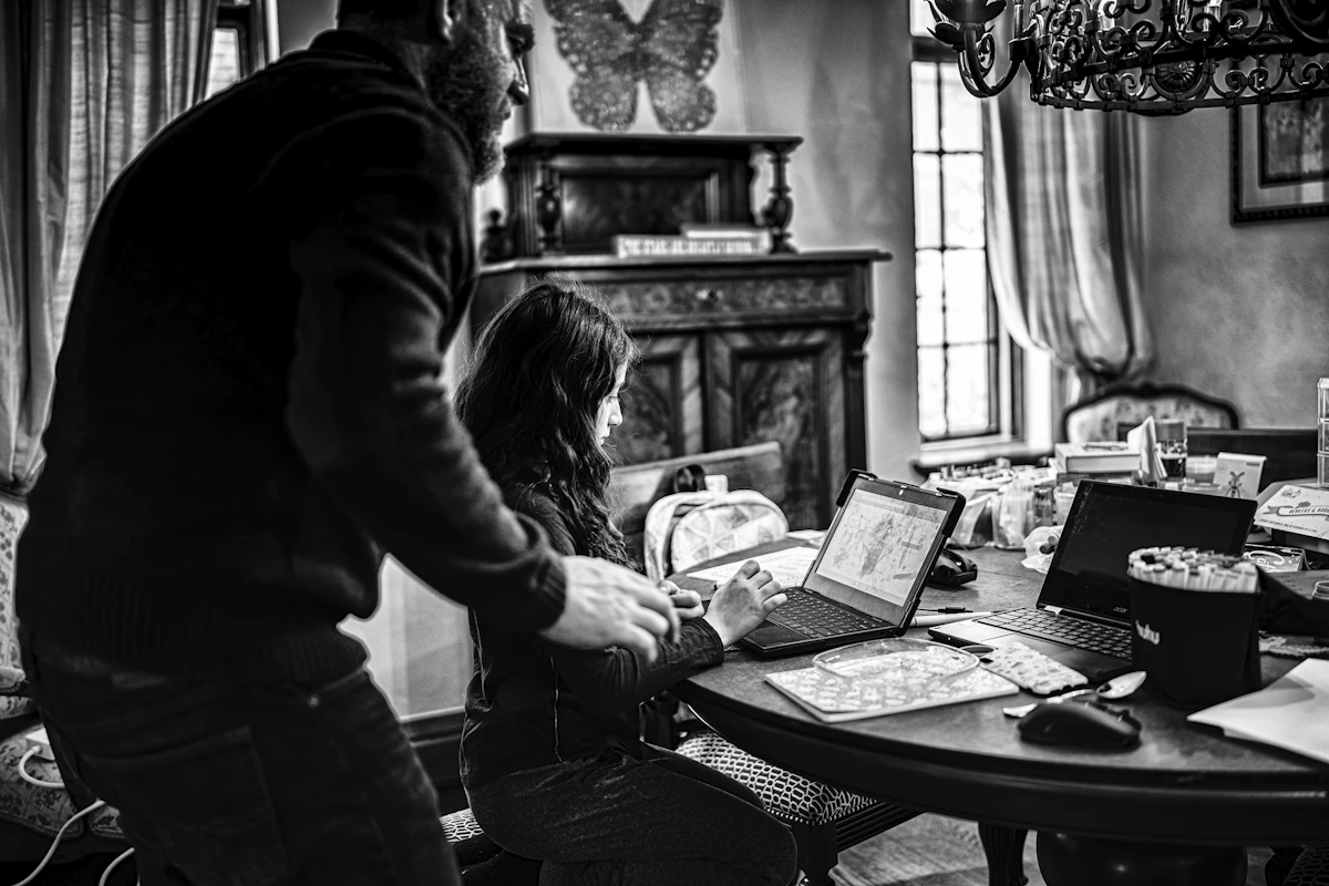 grayscale photo of woman in long sleeve shirt holding book