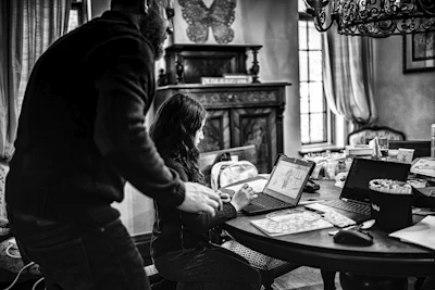 grayscale photo of woman in long sleeve shirt holding book