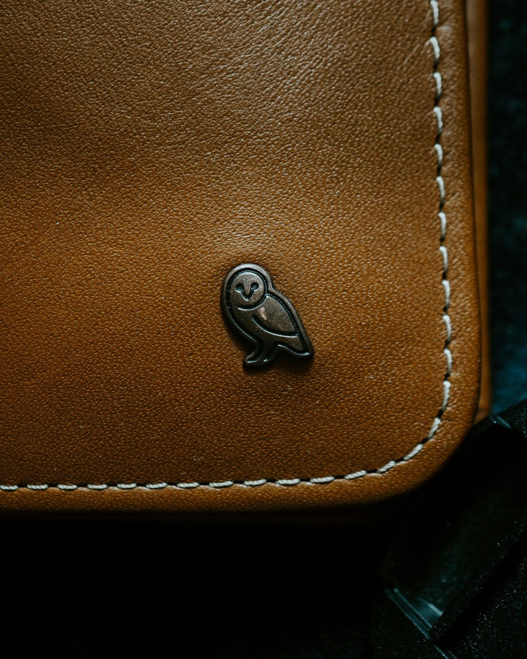 brown leather bag with silver round button