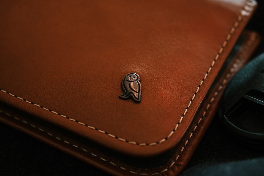 brown leather wallet with silver round coin