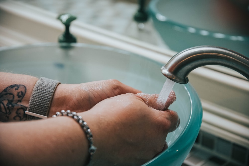 person holding blue ceramic bowl