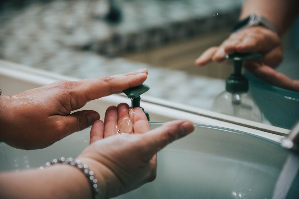 person holding green plastic tube