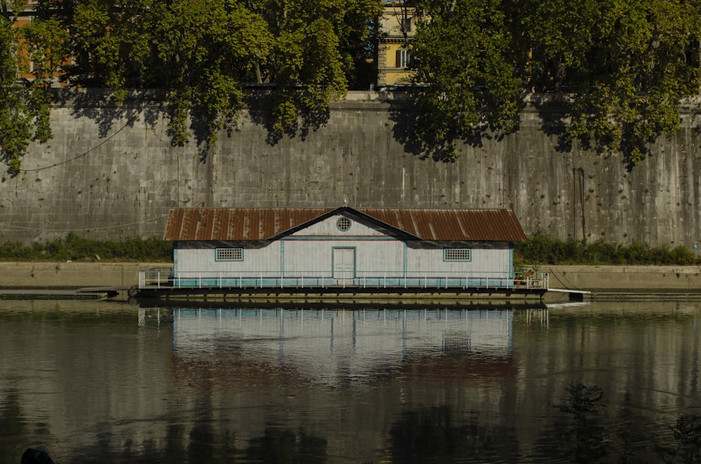 white and brown house beside body of water during daytime