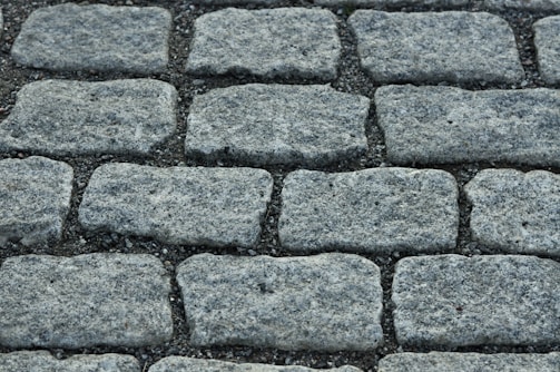 A close-up of a freshly installed stone driveway with clean, precise interlocking patterns.