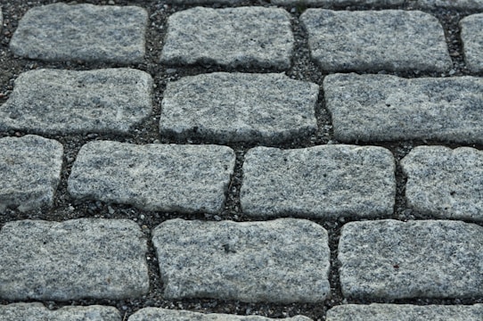 Close-up of freshly laid cobblestone pavement with precise edges.