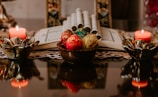 Cultural ritual setup with candles and traditional artifacts on a table