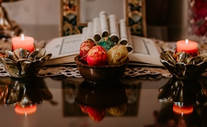 Cultural ritual setup with candles and traditional artifacts on a table