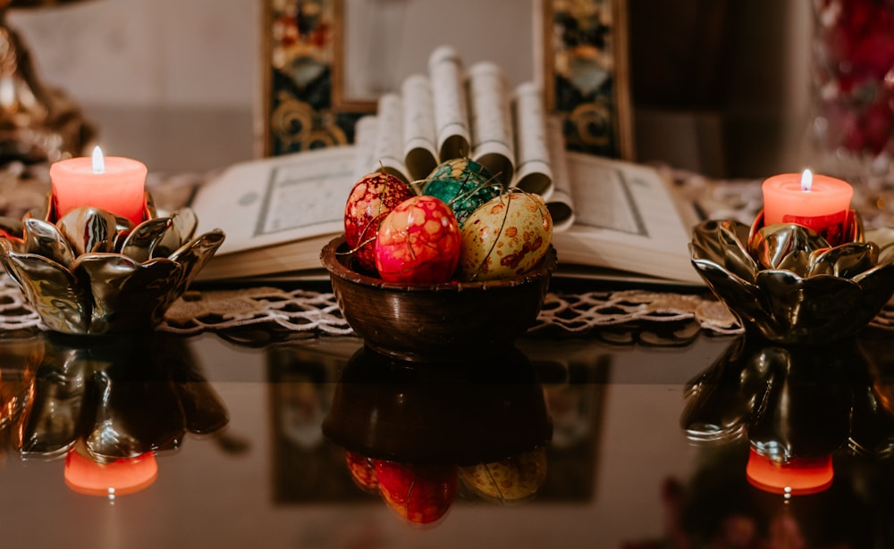 red and green fruit on brown ceramic bowl