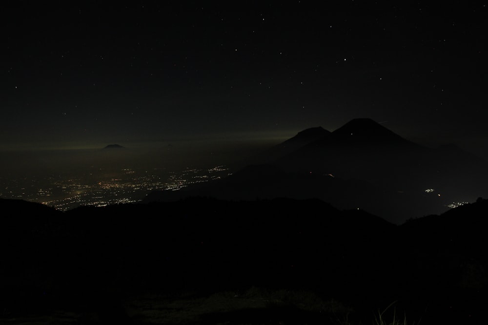 silhouette of mountain during night time