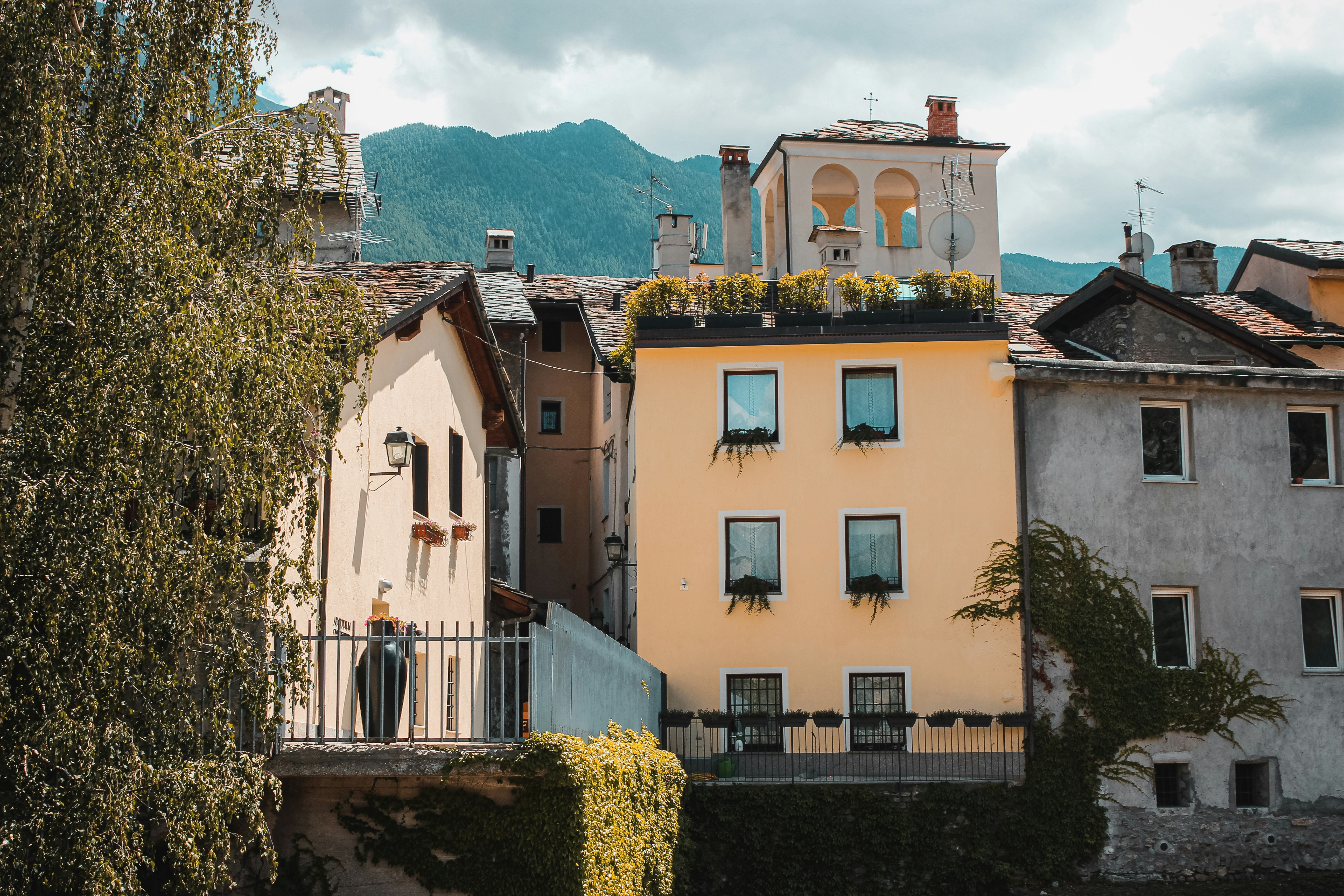 white and brown concrete building near green trees during daytime
