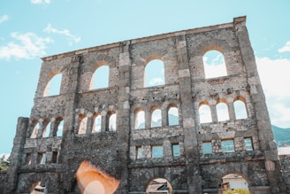 Historic stone architecture of Rijal Almaa village under a clear blue sky.