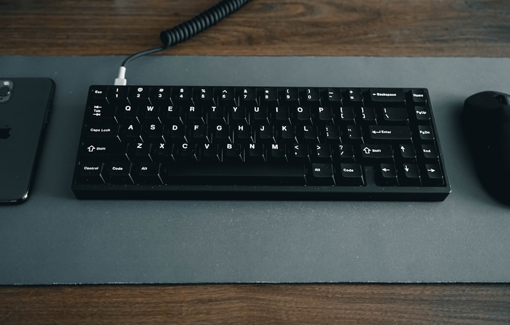 black computer keyboard on brown wooden table