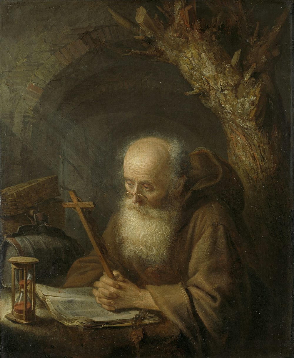 man in brown robe painting