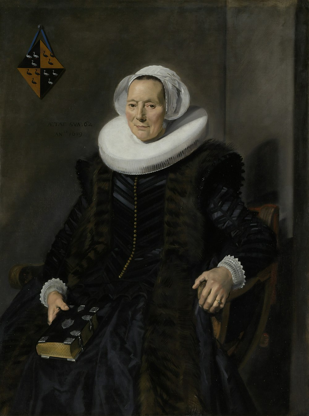 donna in cappotto bianco e nero che si siede sulla sedia