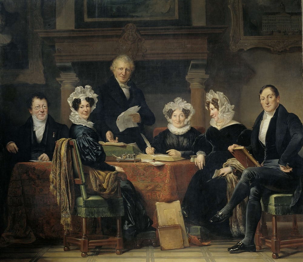 group of people sitting on brown wooden chair