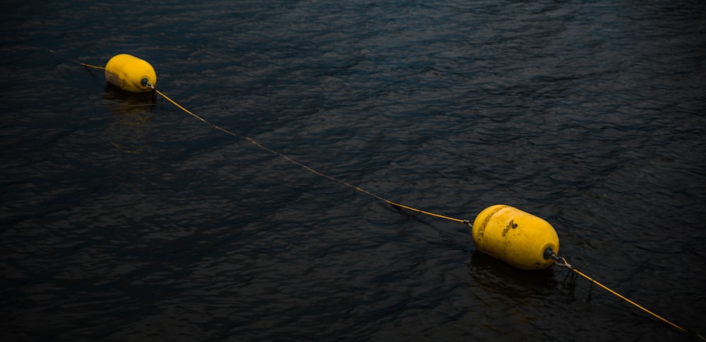 yellow and black fishing rod on body of water during daytime