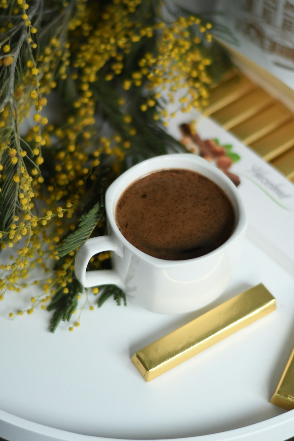 white ceramic mug with brown liquid inside