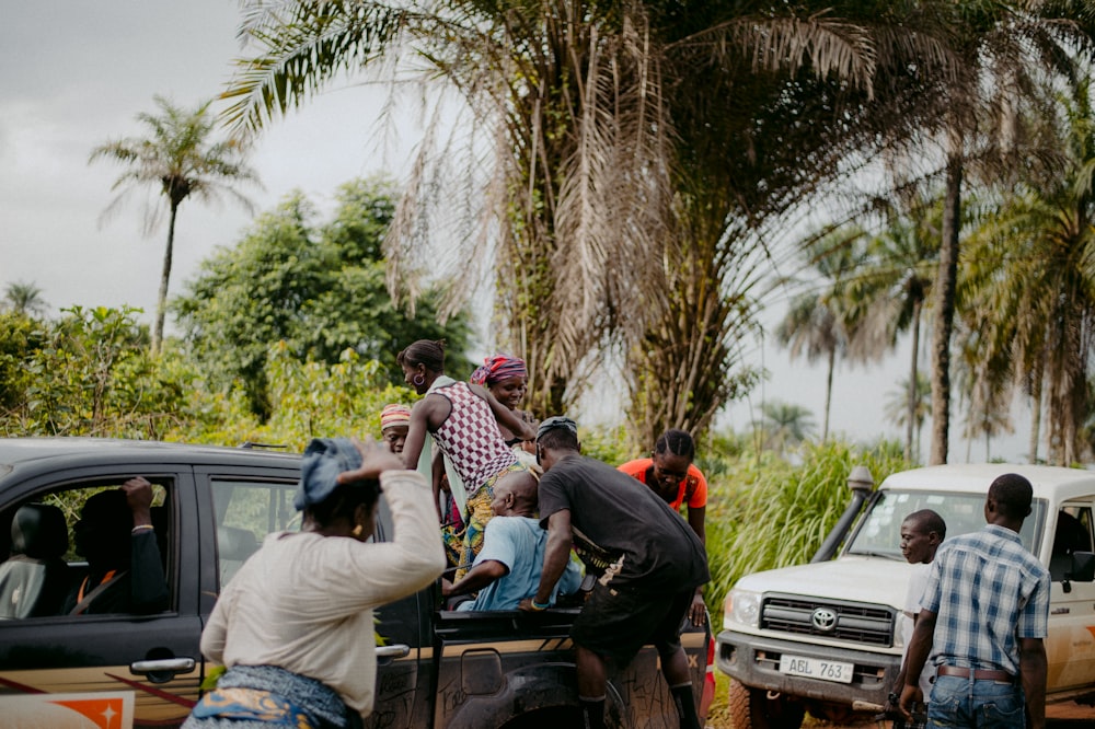 people sitting on black car during daytime