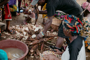 Community members gathered around the Bukoli well, smiling with gratitude.