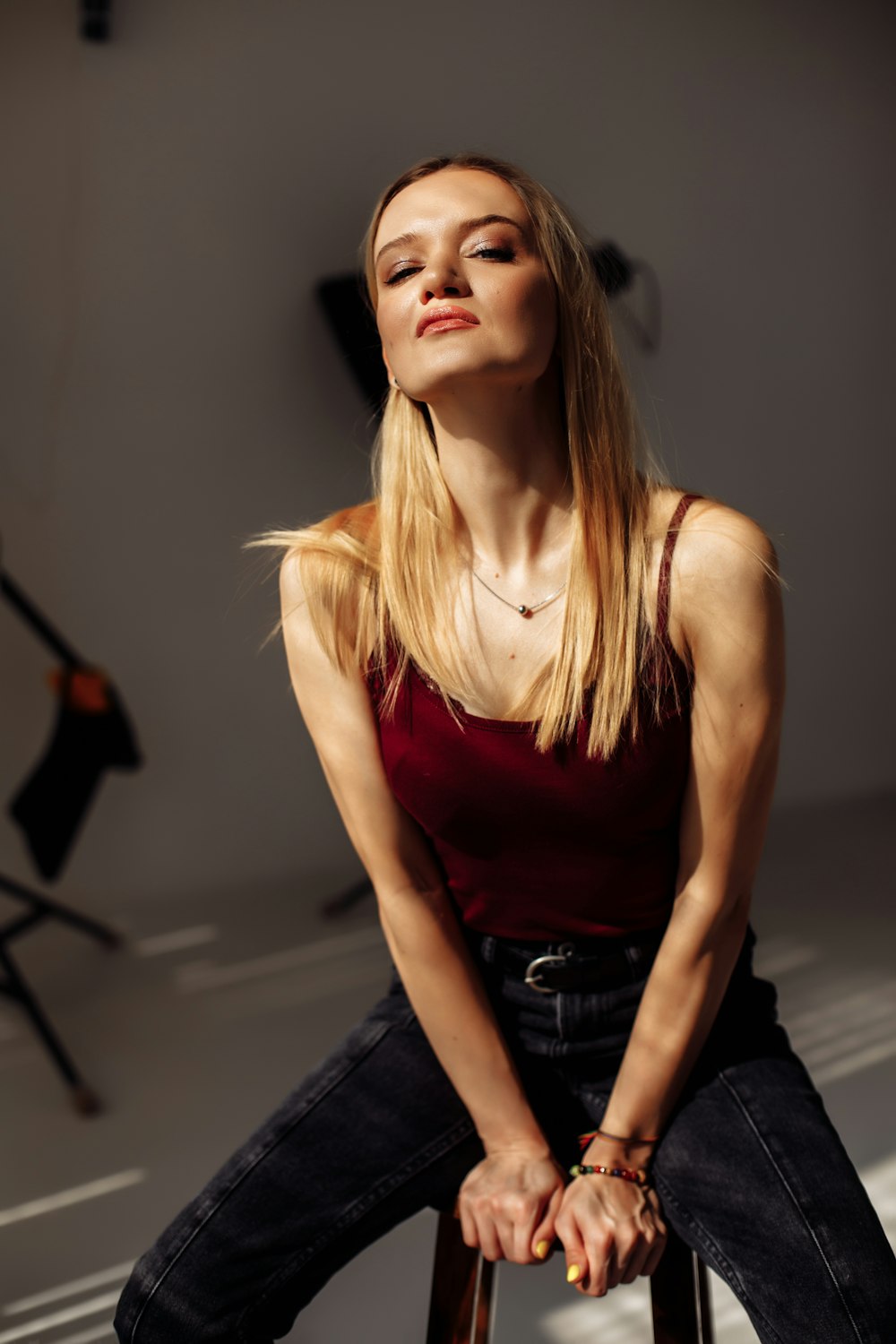 woman in red tank top and blue denim jeans