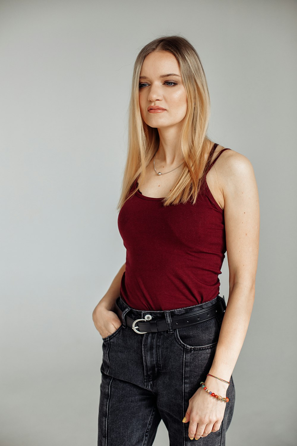 woman in red tank top and blue denim jeans