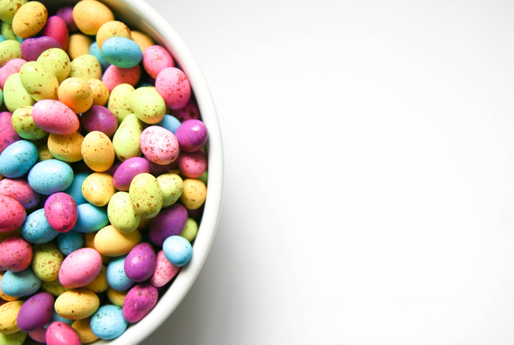 assorted color of candies in white ceramic bowl