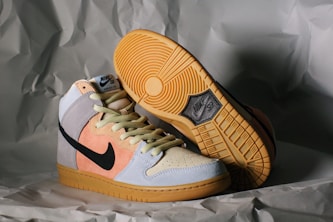 white and orange nike athletic shoes