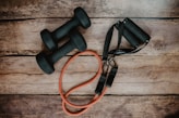 orange and black usb cable on brown wooden surface